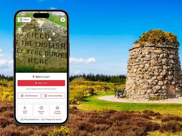 Smartphone displaying Culloden Battlefield tour app with a stone monument in the background