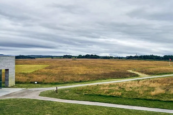 Scenic view of a wide grassy field with paths at Culloden Battlefield
