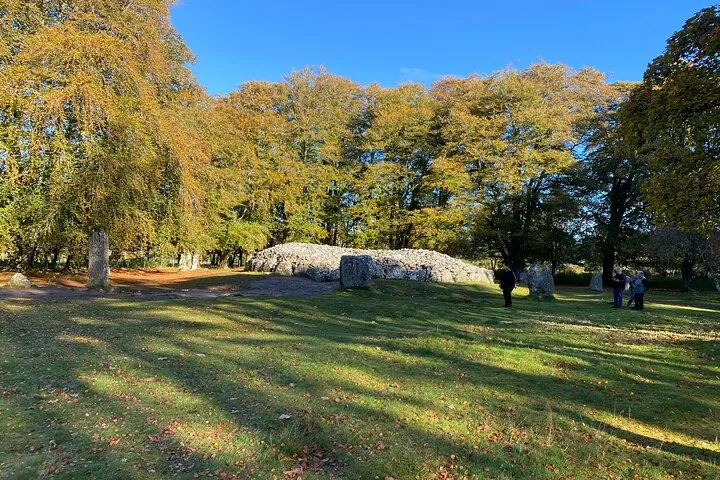 Clava Cairns, a bronze age circular chamber tomb surrounded by autumn trees