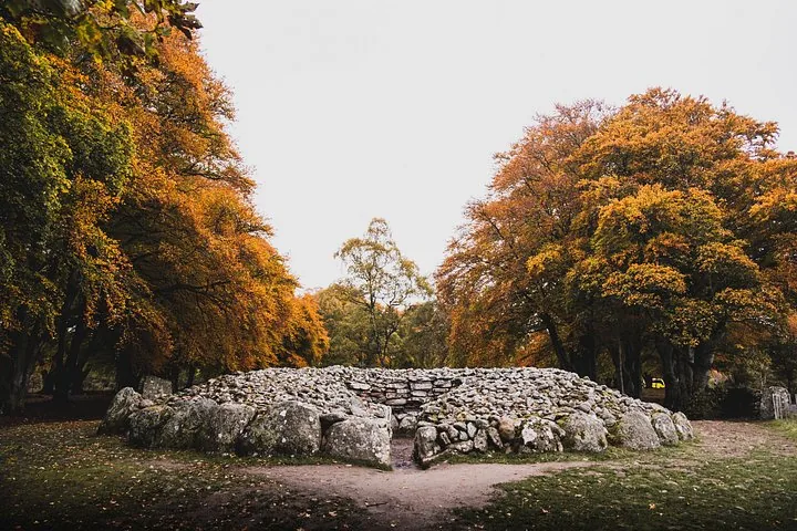 Clava Cairns circular stone burial monument surrounded by trees in autumn foliage